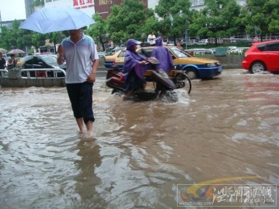 電動車和行人匆匆穿過芙蓉路的引橋，仍然還是要卷起褲腿。　　陳劍岷 攝 圖片來源：星辰在線